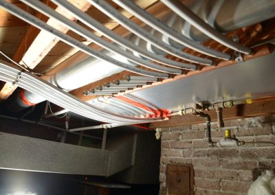 Water lines run through a basement ceiling