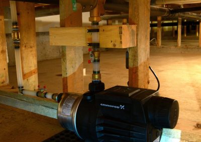 Pump installation under a building