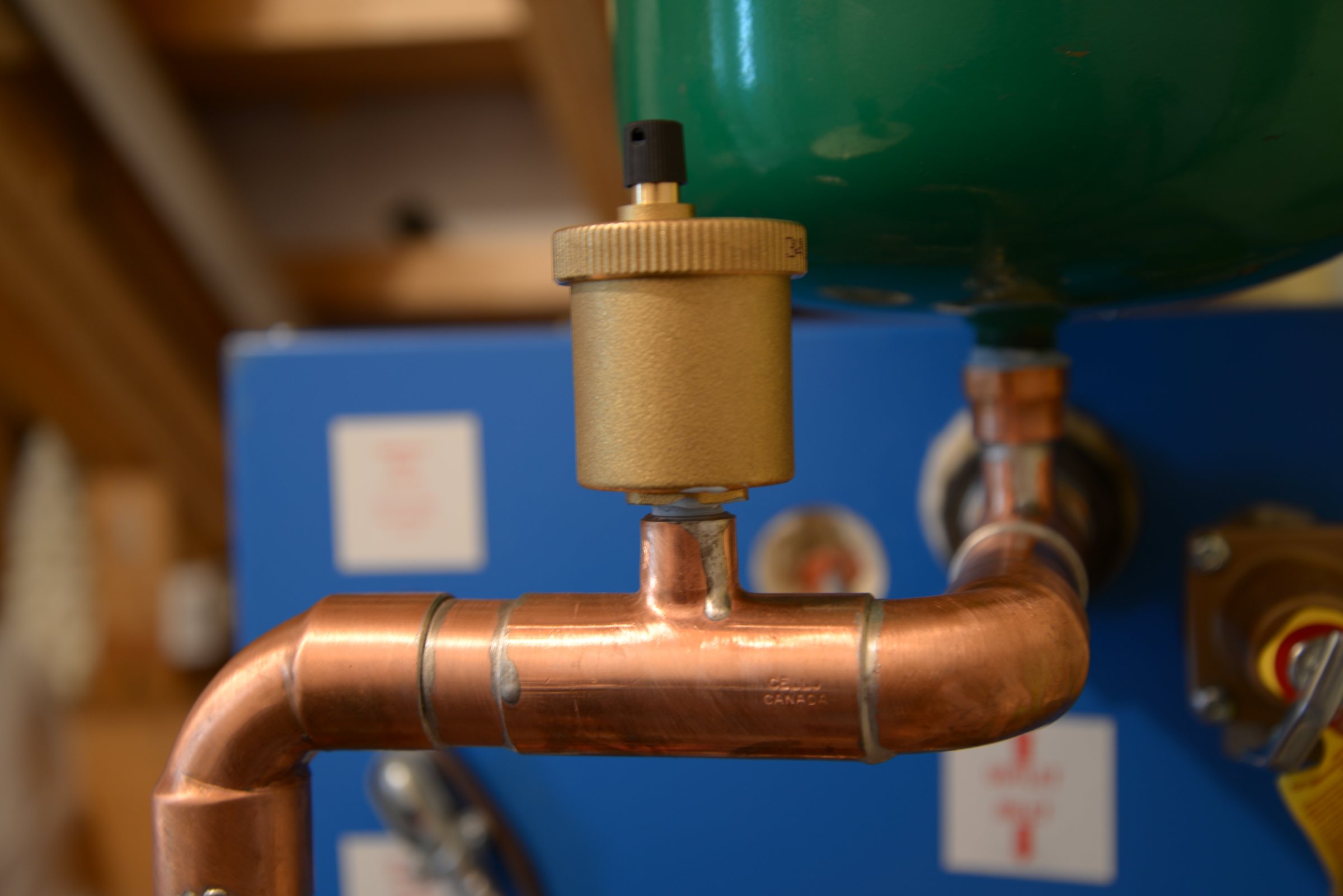 Copper piping and air vent on a boiler