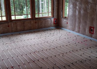 In-floor heating loops in a bay window room