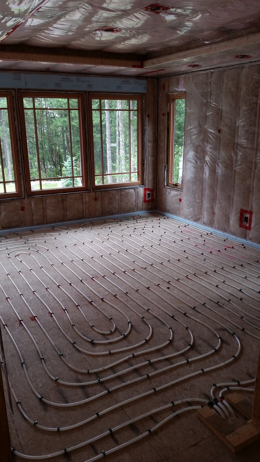 In-floor heating loops in a bay window room