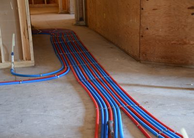 PEX lines run across a new floor